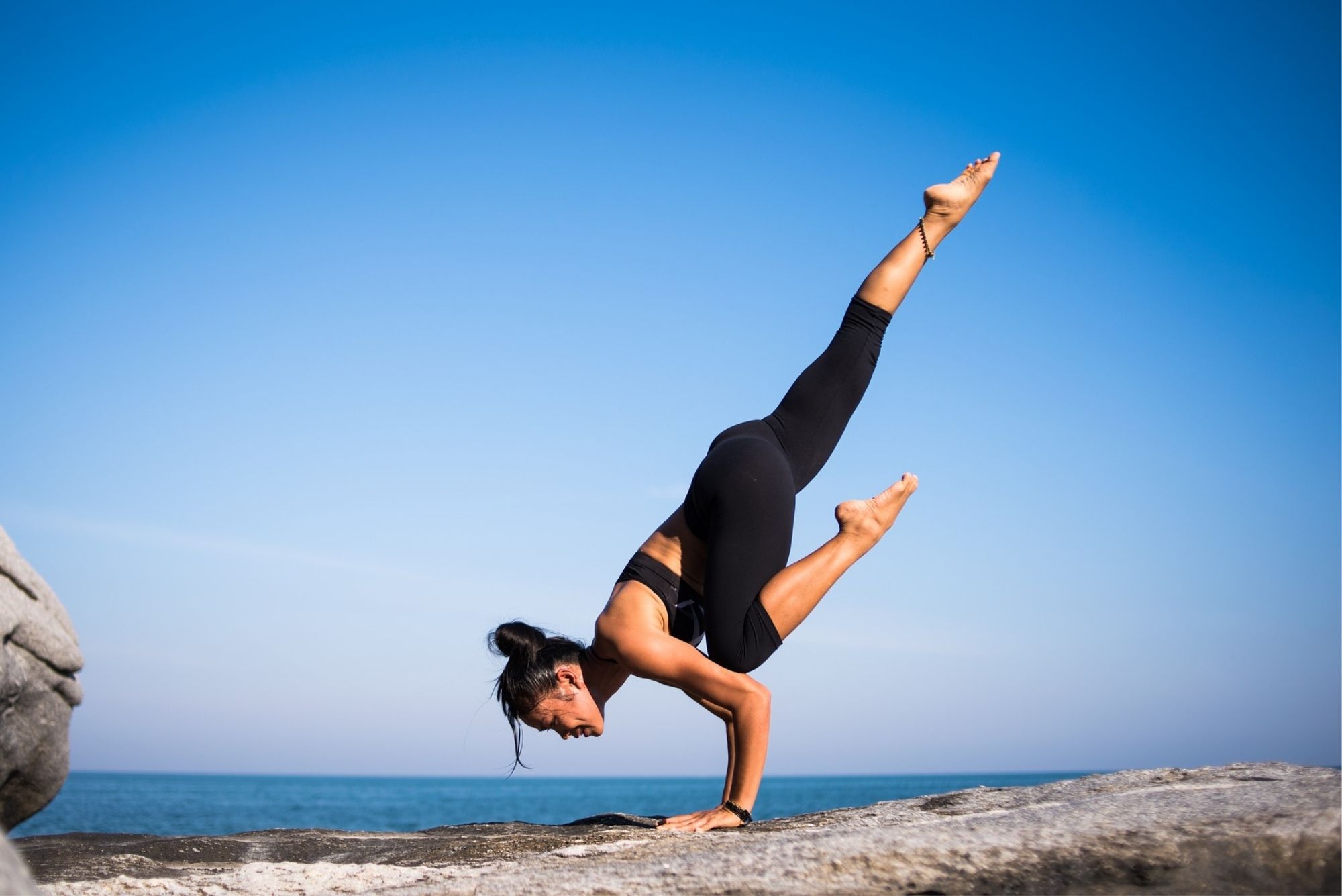 smiling woman in sitting prayer pose