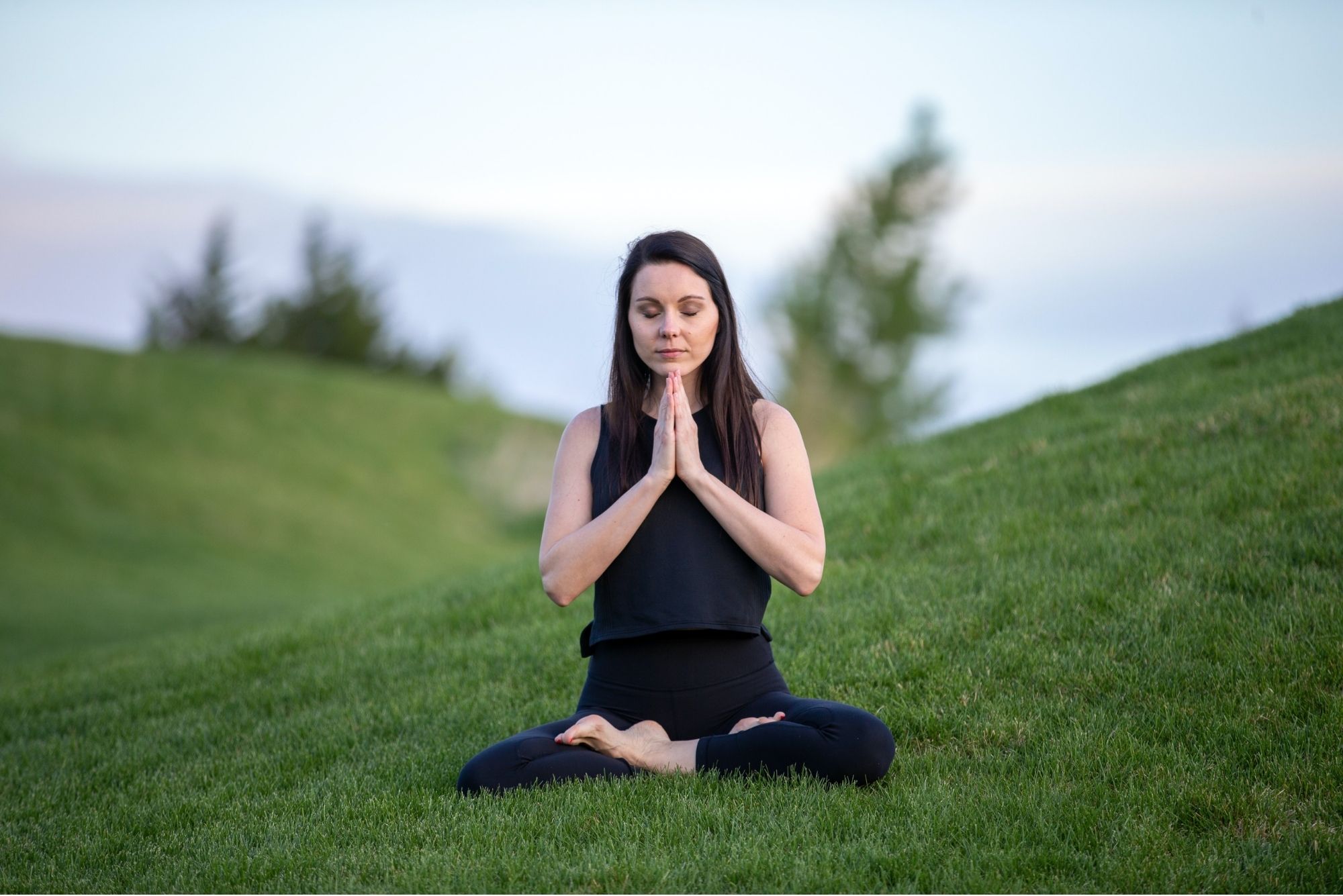 smiling woman in sitting prayer pose